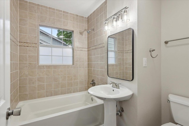 bathroom featuring shower / bath combination and toilet