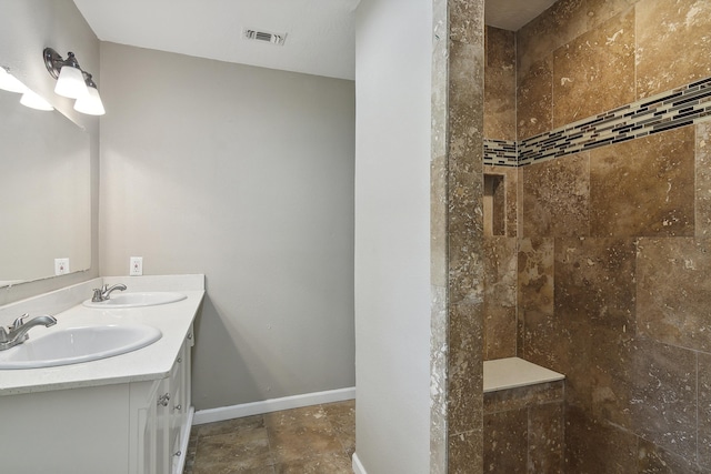 bathroom featuring vanity and tiled shower