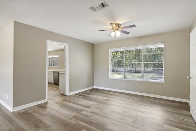 unfurnished room with ceiling fan and light hardwood / wood-style flooring