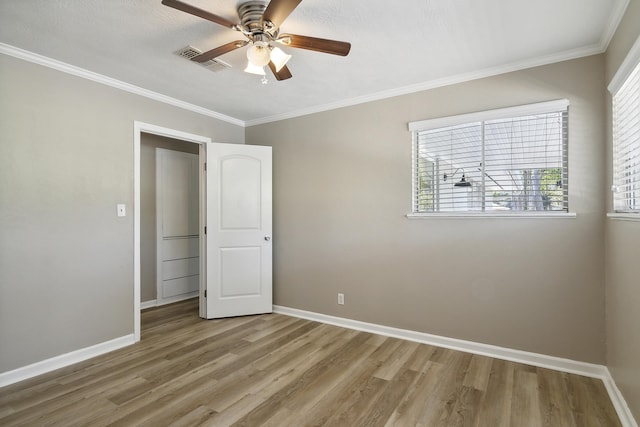 unfurnished bedroom with light hardwood / wood-style flooring, ceiling fan, and crown molding