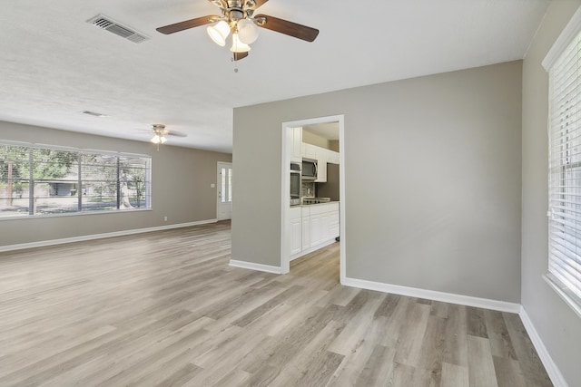 interior space with light wood-type flooring and ceiling fan