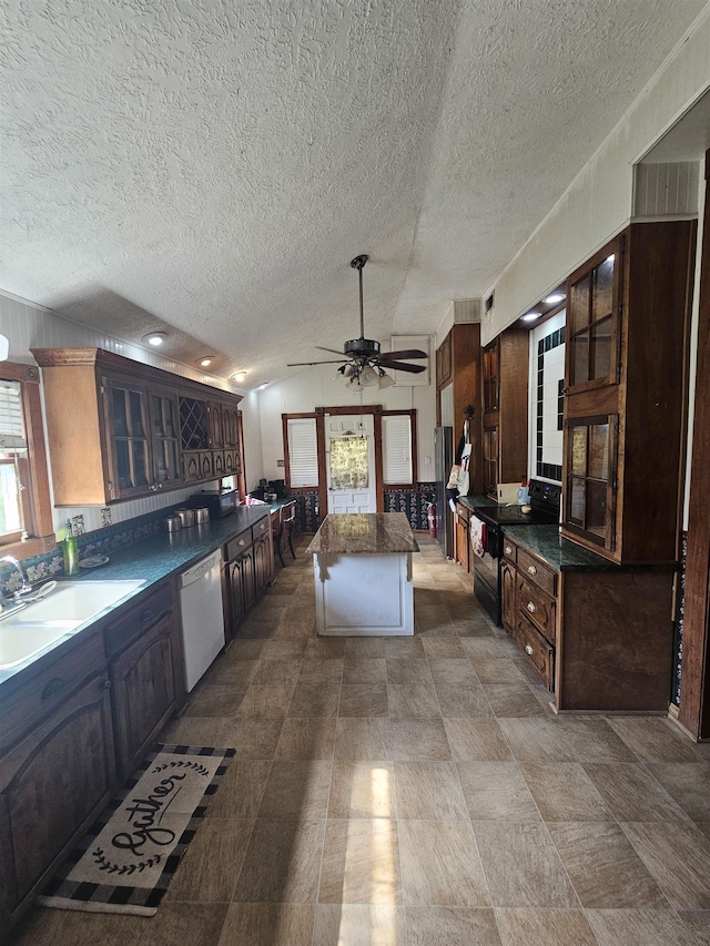 kitchen featuring dark brown cabinets, white dishwasher, wooden walls, black electric range, and a kitchen island