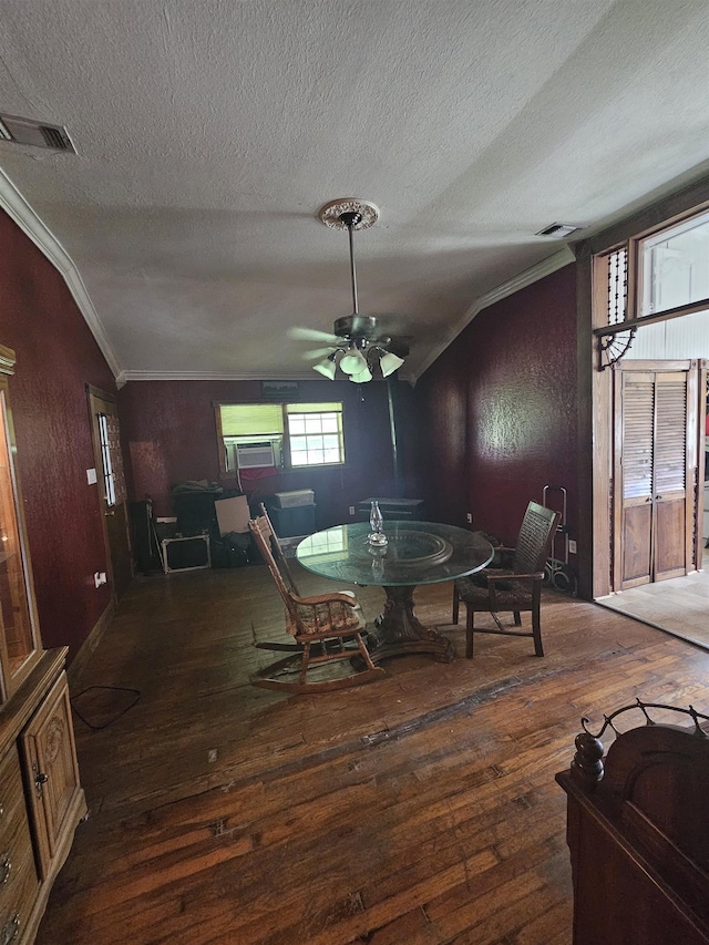 dining space with ornamental molding, vaulted ceiling, ceiling fan, and dark wood-type flooring