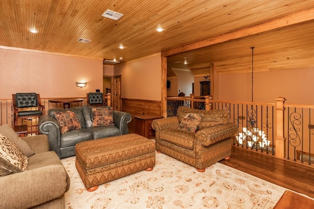 living room with hardwood / wood-style flooring, ornamental molding, and wood ceiling