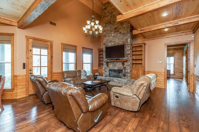 living room featuring hardwood / wood-style floors, an inviting chandelier, a fireplace, a healthy amount of sunlight, and wood ceiling