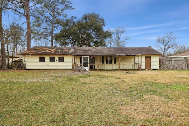 rear view of property with a yard