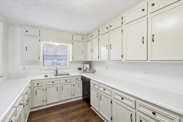 kitchen with dark hardwood / wood-style floors, white cabinetry, black dishwasher, sink, and a textured ceiling