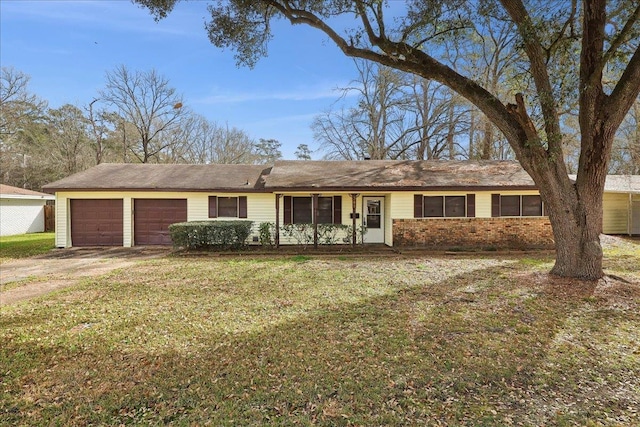 single story home featuring a garage and a front yard