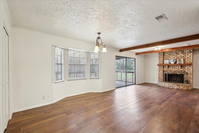 unfurnished living room with a fireplace, beamed ceiling, a textured ceiling, dark hardwood / wood-style flooring, and a chandelier