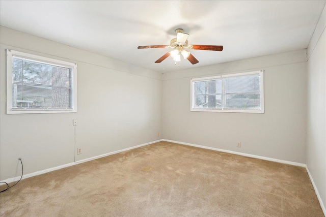 carpeted spare room with ceiling fan