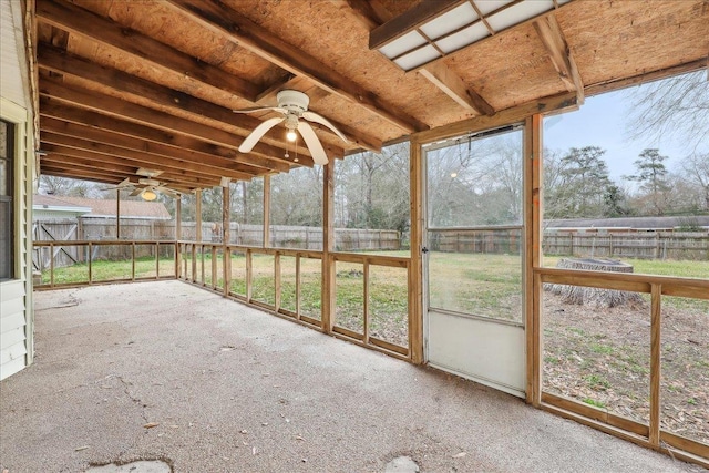 unfurnished sunroom featuring ceiling fan