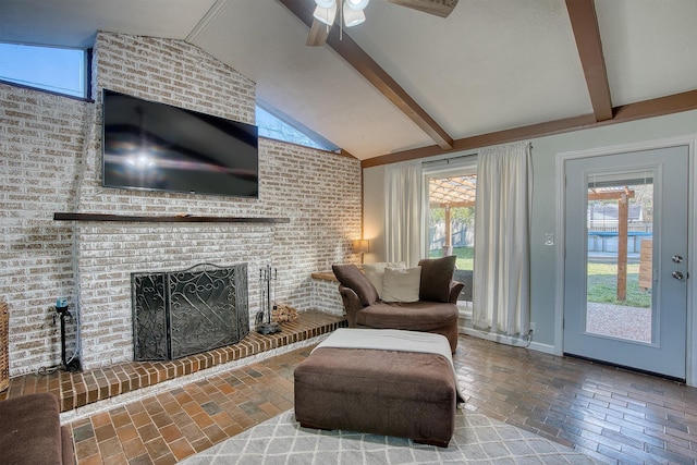 living room with lofted ceiling with beams, a healthy amount of sunlight, and a fireplace