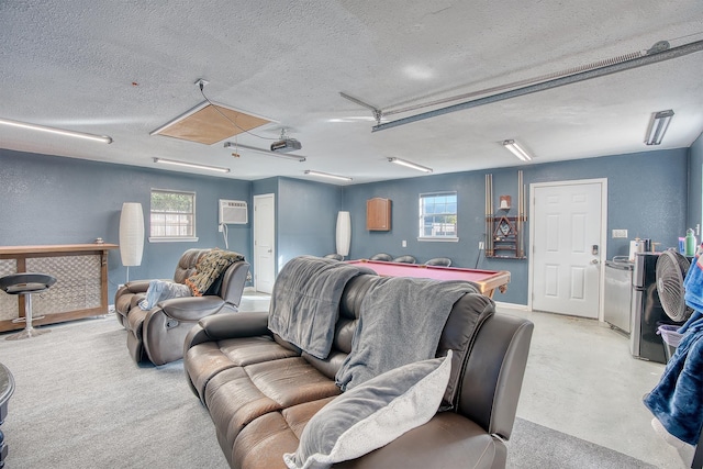 home theater room with a textured ceiling, a wall mounted AC, and billiards