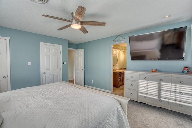 bedroom featuring ensuite bathroom, ceiling fan, and light colored carpet