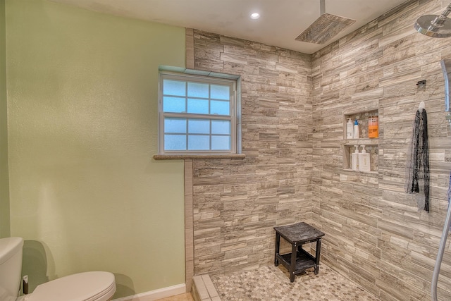 bathroom featuring tile patterned floors, a shower, and toilet