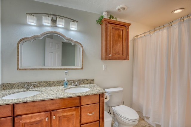 bathroom with tile patterned floors, vanity, and toilet