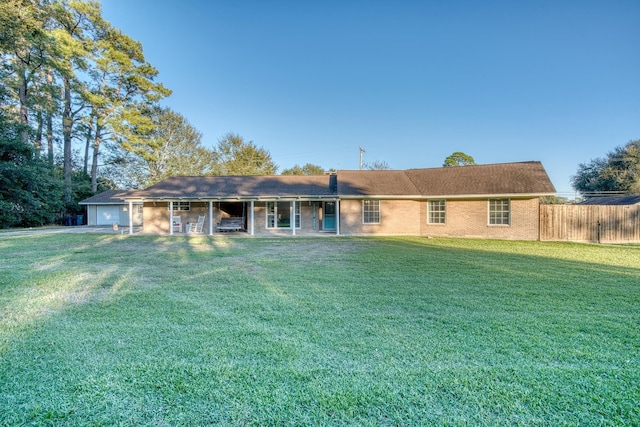 ranch-style house with a garage and a front lawn