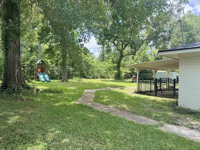 view of yard with fence and a playground