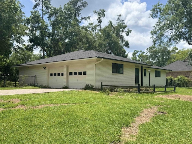 ranch-style house featuring fence, a front lawn, driveway, and an attached garage