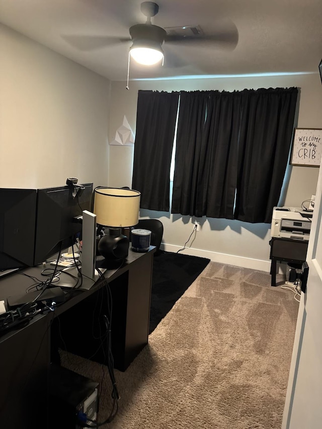 carpeted office featuring a ceiling fan