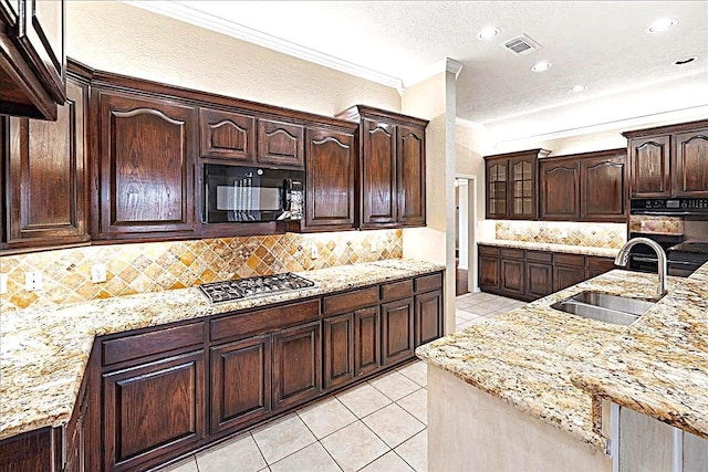 kitchen with sink, crown molding, black appliances, and dark brown cabinetry