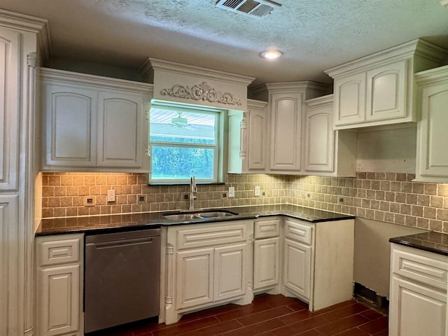 2003 Craig St, Orange, TX 77630 - kitchen with dishwasher, dark wood-style flooring, decorative backsplash, white cabinetry, and a textured ceiling