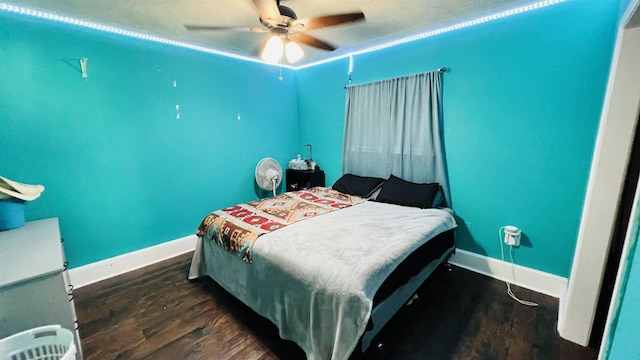 bedroom featuring dark hardwood / wood-style flooring and ceiling fan