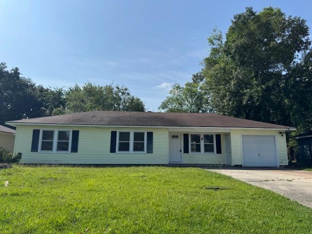 6 Circle Q St, Orange, TX 77630 - single story home with a garage, concrete driveway, and a front lawn
