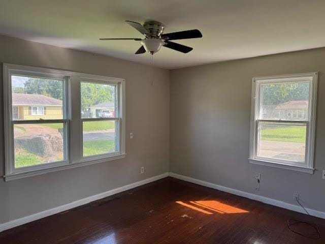 6 Circle Q St, Orange, TX 77630 - empty room featuring plenty of natural light, baseboards, dark wood finished floors, and ceiling fan