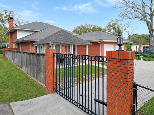 view of gate featuring a lawn