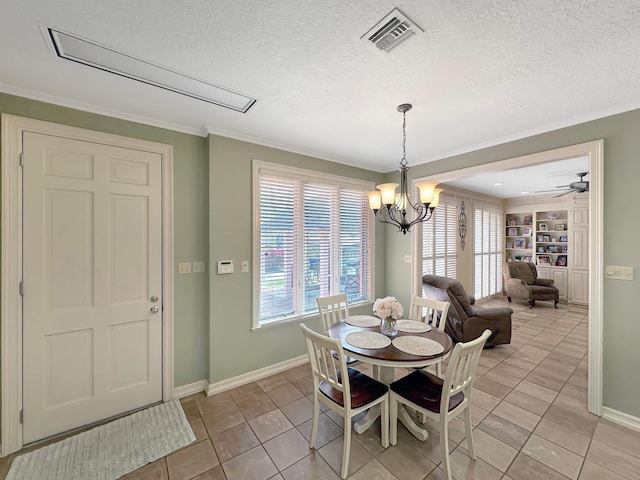 tiled dining space with a textured ceiling, built in shelves, ceiling fan with notable chandelier, and ornamental molding