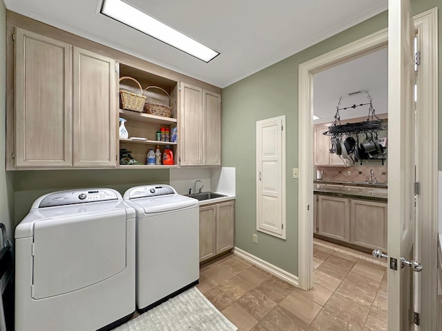 laundry room featuring cabinets, separate washer and dryer, and sink