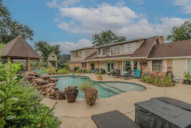 outdoor pool with a patio and a gazebo