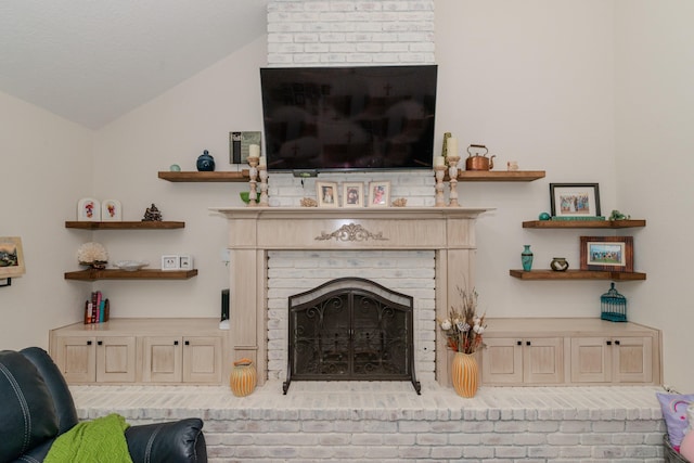 living room with lofted ceiling and a fireplace