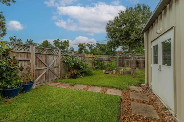 view of yard with a gate, a garden, and fence