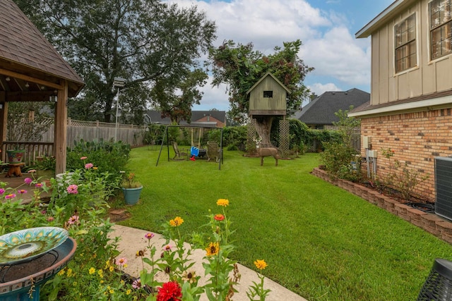 view of yard with a fenced backyard and a playground