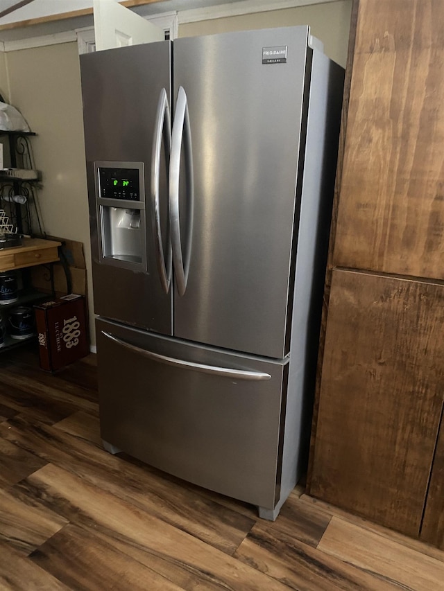 kitchen featuring stainless steel fridge and wood finished floors