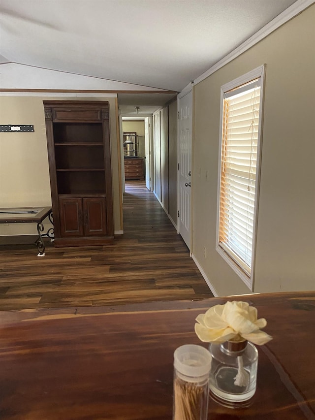 hallway with ornamental molding and dark wood-type flooring