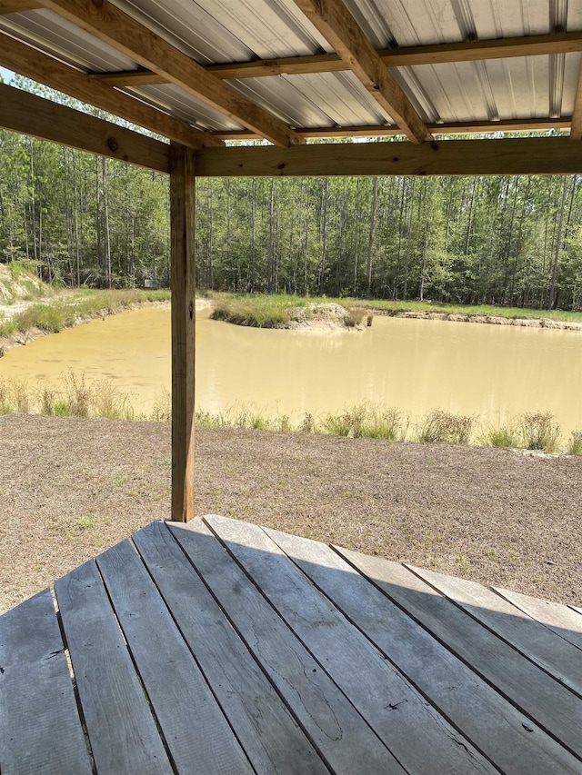 view of patio / terrace with a water view and a view of trees