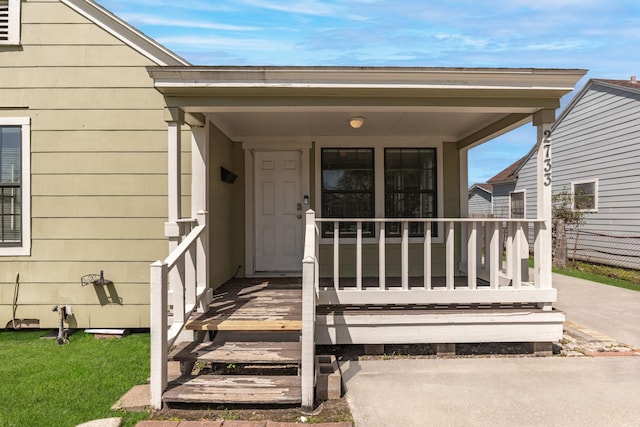 view of exterior entry with covered porch