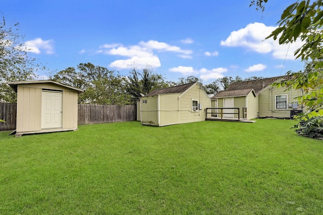 view of yard with a fenced backyard, a shed, and an outdoor structure