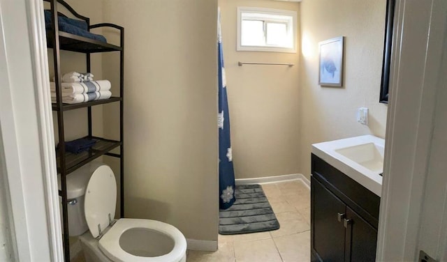 full bath with baseboards, toilet, vanity, and tile patterned flooring