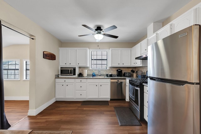 kitchen featuring appliances with stainless steel finishes, white cabinetry, a ceiling fan, and a sink