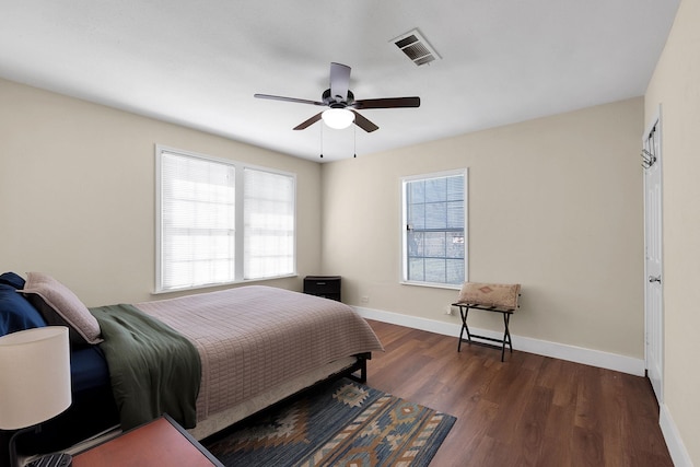 bedroom featuring multiple windows, dark wood-style floors, visible vents, and baseboards