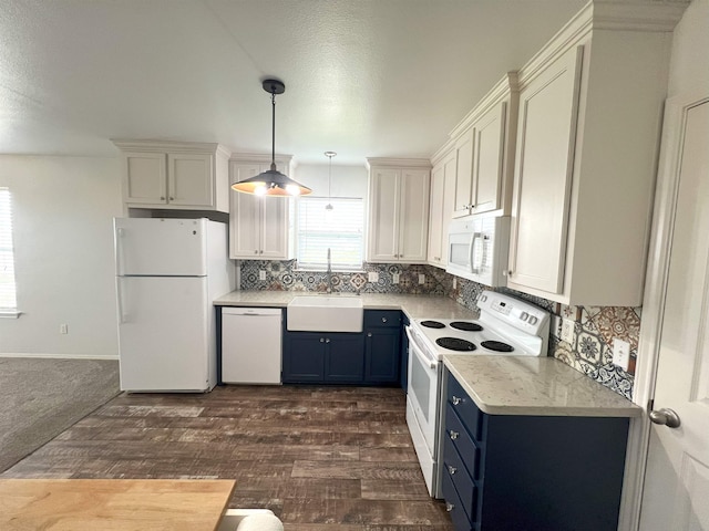 kitchen with white appliances, blue cabinets, sink, decorative light fixtures, and white cabinets