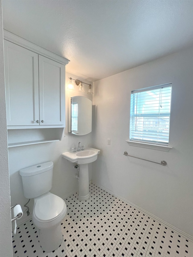 bathroom featuring tile patterned flooring and toilet