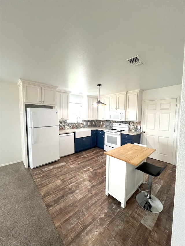 kitchen featuring hanging light fixtures, blue cabinets, white appliances, a kitchen bar, and white cabinets