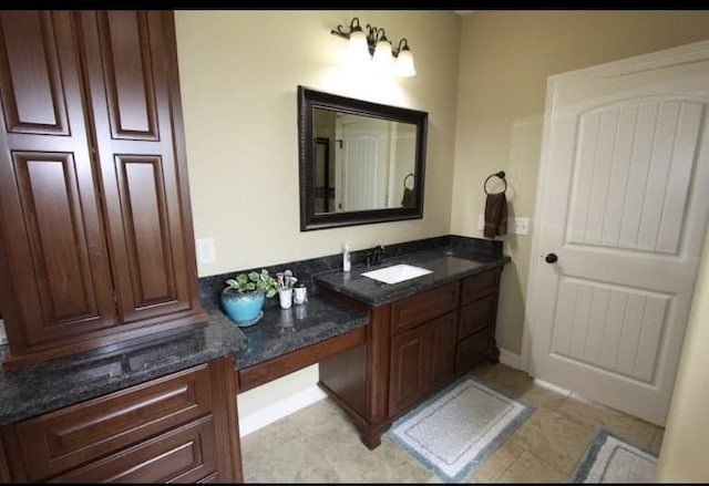 bathroom with tile patterned flooring and vanity