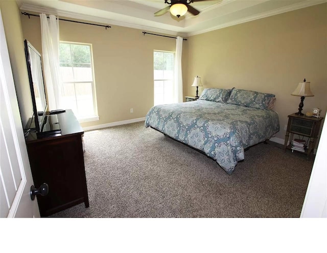 bedroom with carpet floors, a raised ceiling, ceiling fan, and crown molding