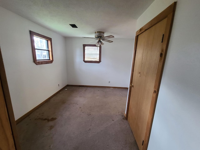 empty room featuring ceiling fan and a textured ceiling